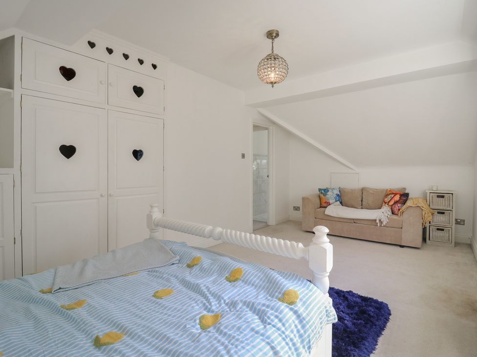 A bedroom with a bed and wardrobe at Panel Place near Pett