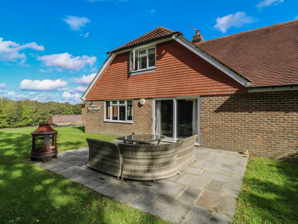 A house with outdoor seating and a patio at Panel Place near Pett