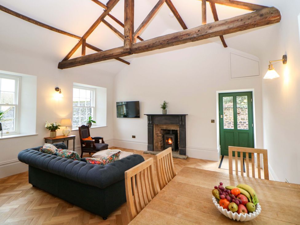 A living room with a sofa and fireplace at The Reading Room in Hope Valley