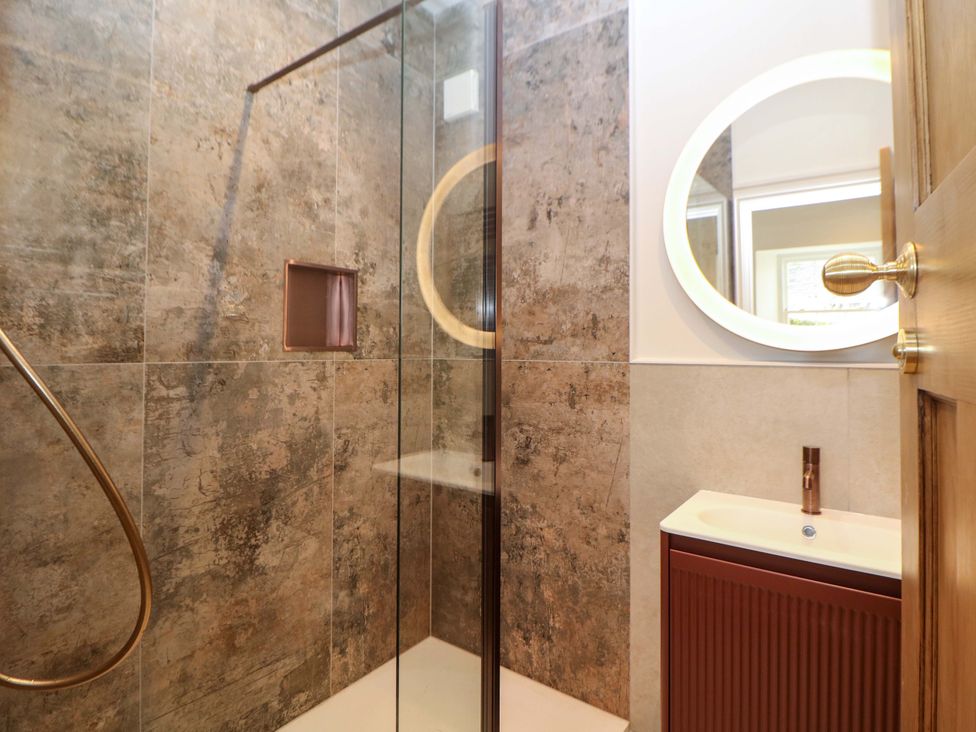 A bathroom with a shower and sink at The Reading Room in Hope Valley