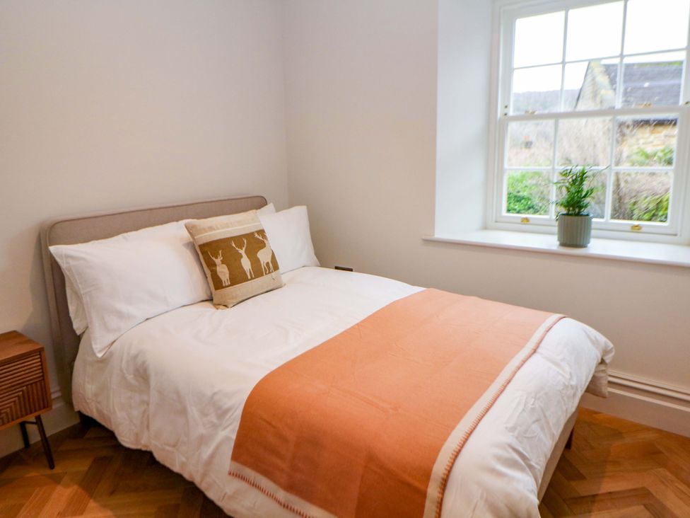 A bedroom with a double bed and a window at The Reading Room in Hope Valley
