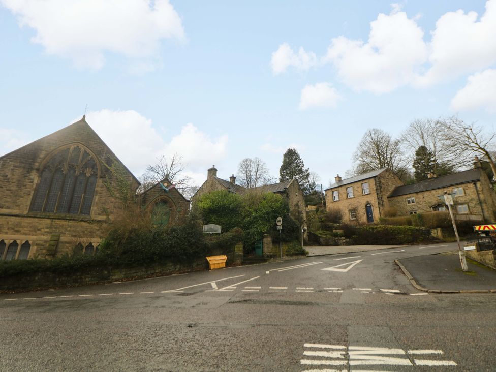 A view of a church and houses along a street in Hope Valley