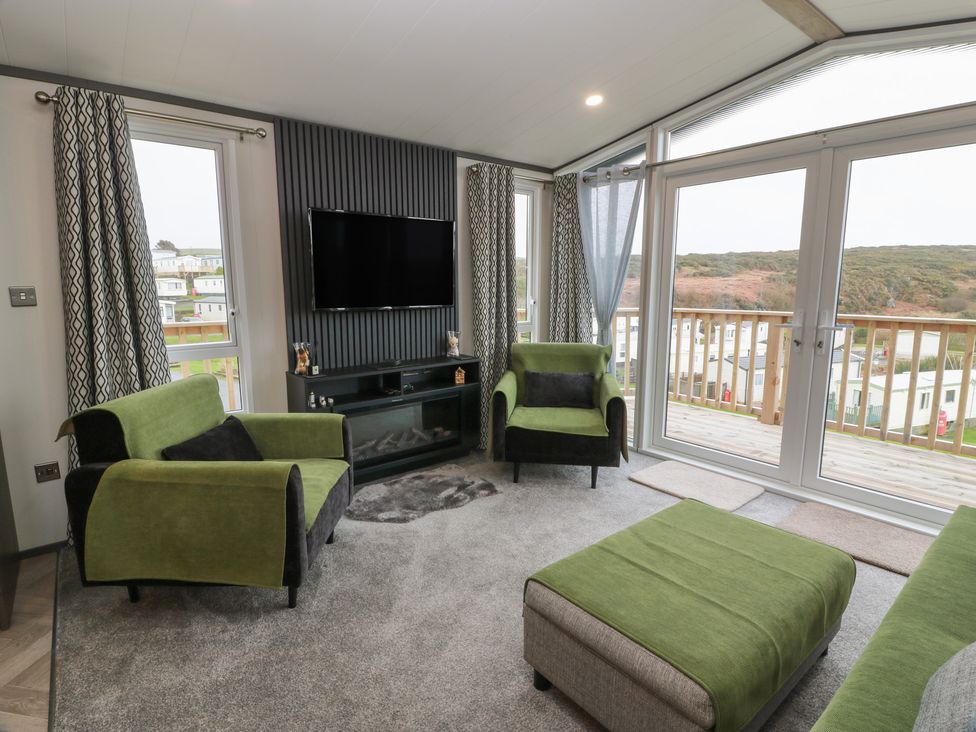 A living room with a sofa and television at Willow's Way in Stranraer