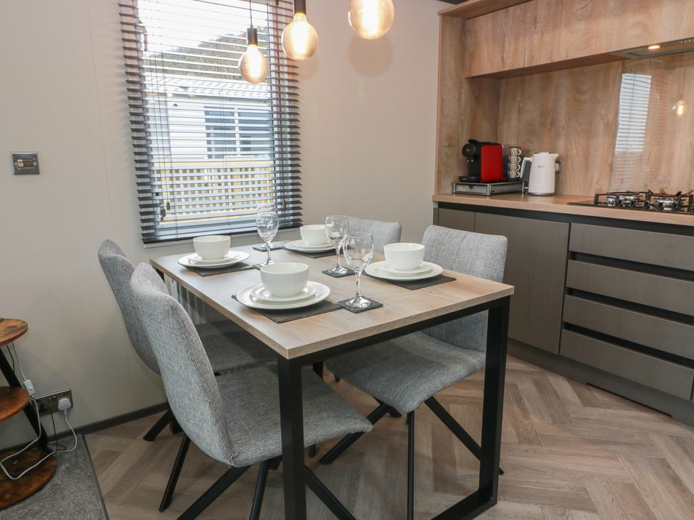 A dining area with a table and chairs at Willow's Way in Stranraer