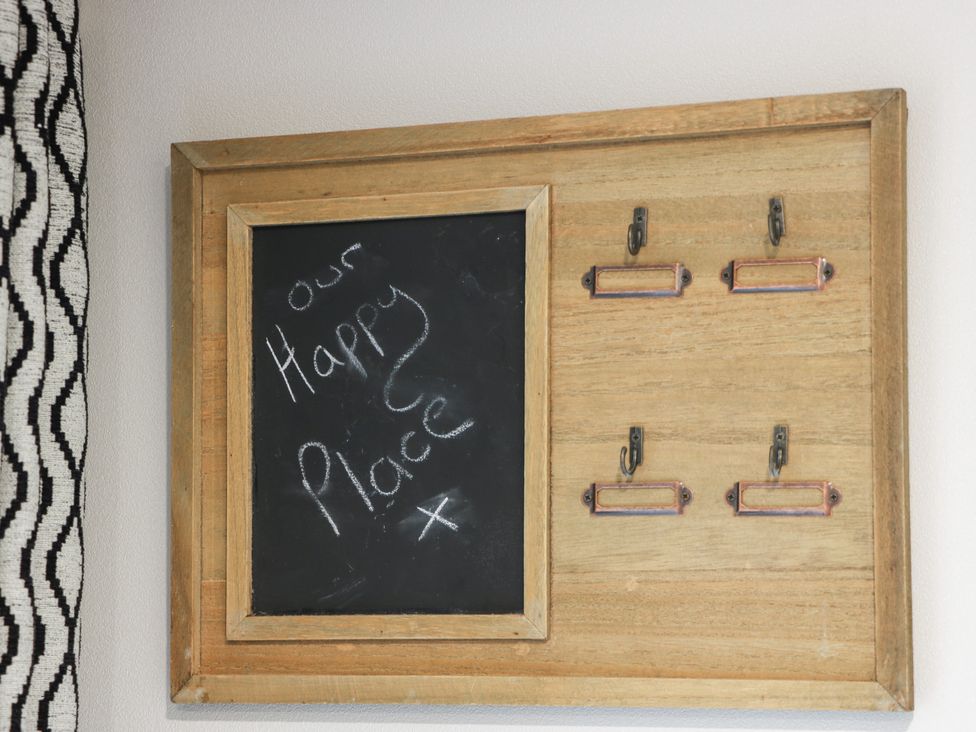 A chalkboard with hooks on a wall at Willow's Way in Stranraer