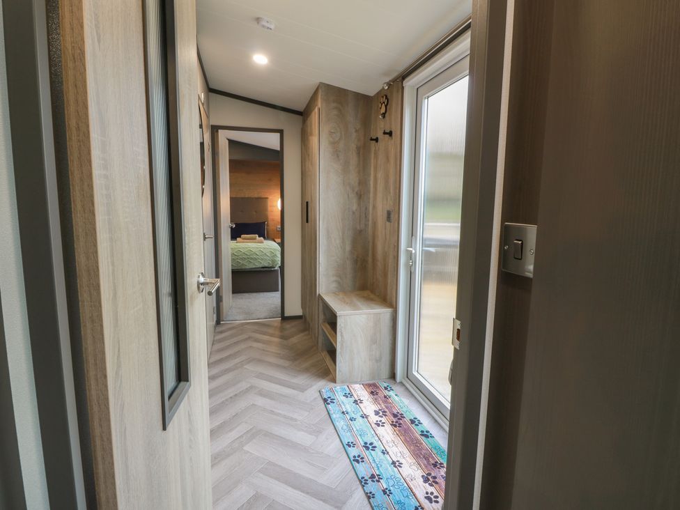 A hallway with a bench and window at Willow's Way in Stranraer