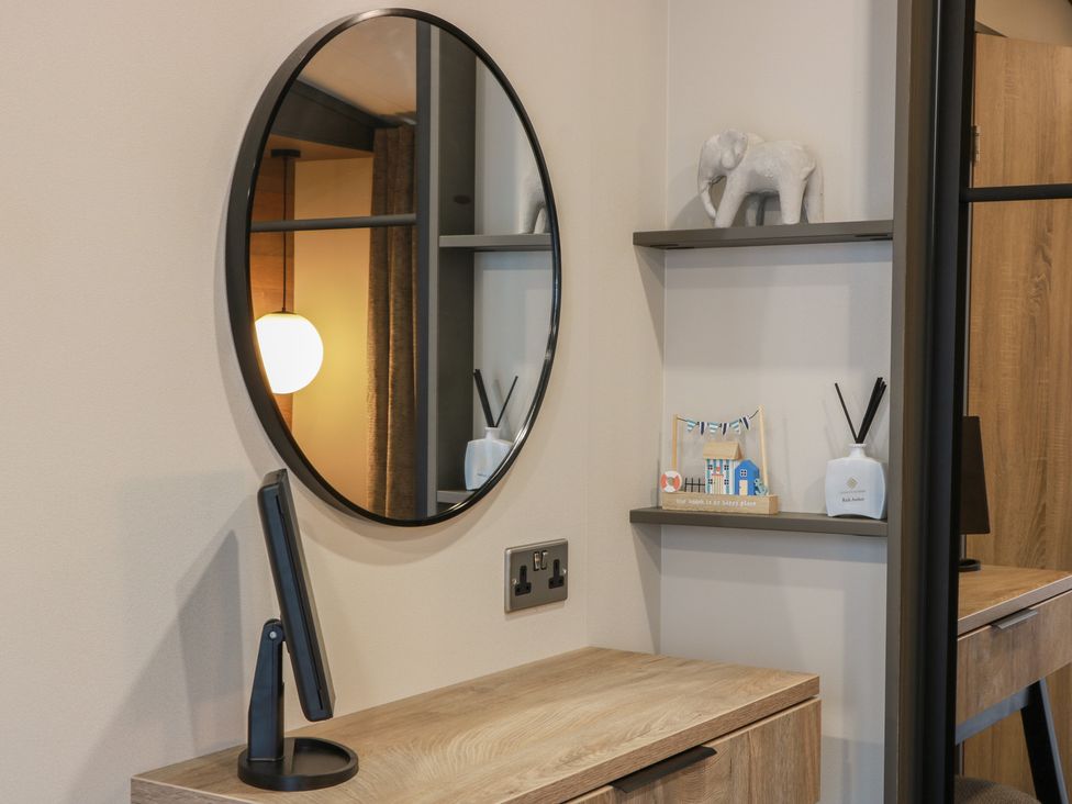An office with a mirror, shelf, and decorative items at Willow's Way in Stranraer