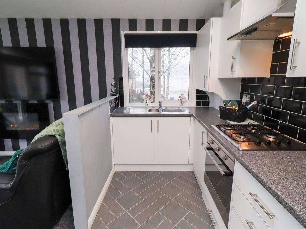 A kitchen with a sink and stove at Harper's Hideaway near Felmoor Holiday Park