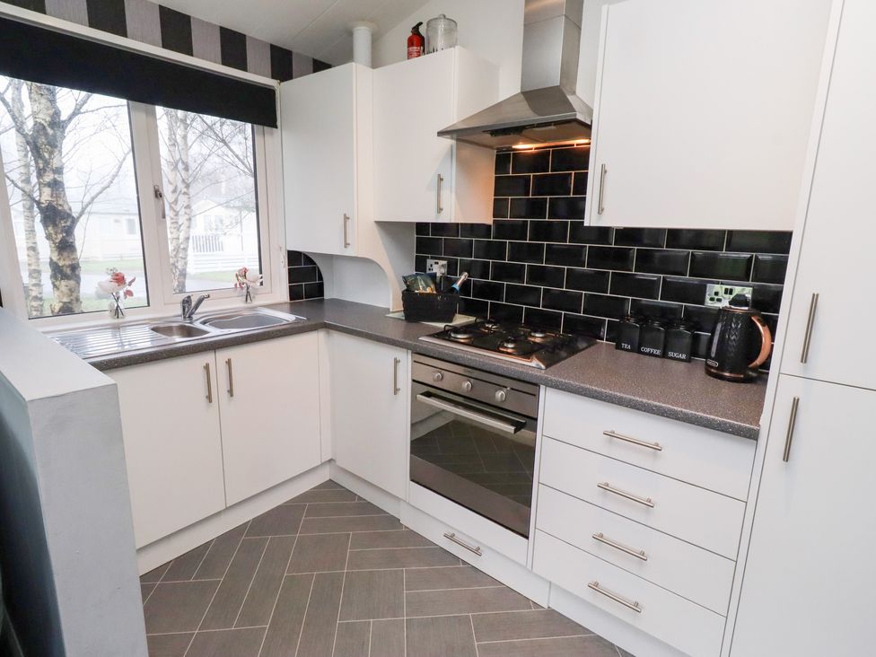 A kitchen with stove and sink at Harper's Hideaway near Felmoor Holiday Park near Felton