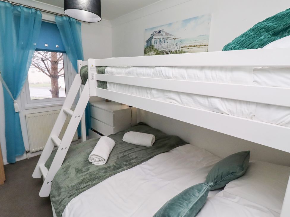 A bedroom with a bunk bed and a dresser at Harper's Hideaway near Felmoor Holiday Park near Felton