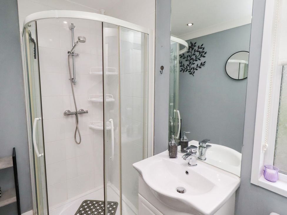 A bathroom with a shower and sink at Harper's Hideaway near Felmoor Holiday Park