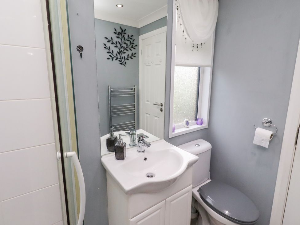 A bathroom with a sink and toilet at Harper's Hideaway near Felmoor Holiday Park near Felton