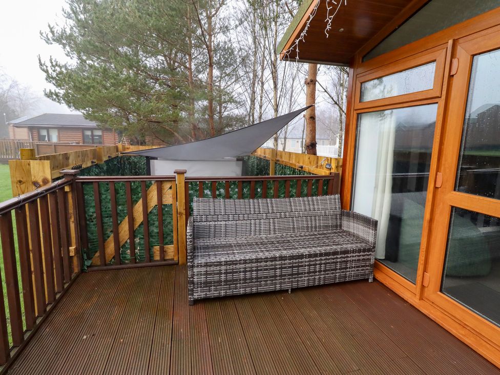 An outdoor space with a sofa and railing at Harper's Hideaway near Felmoor Holiday Park near Felton
