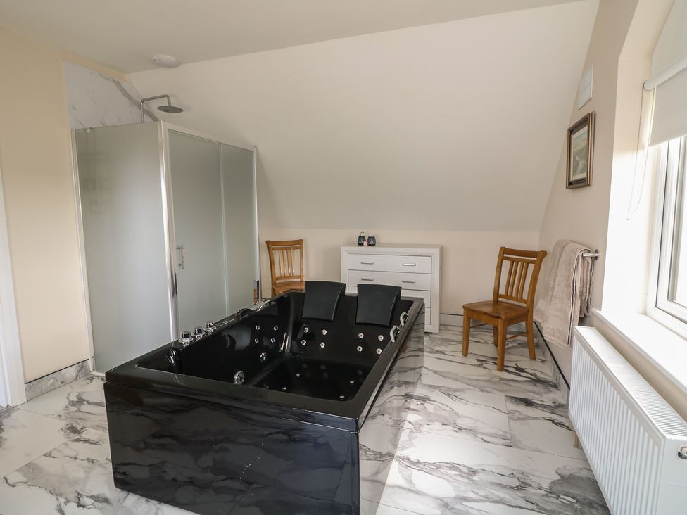 A bathroom with a black bathtub and shower at Ard Uisce @ Estuary Bliss, Duncannon, County Wexford