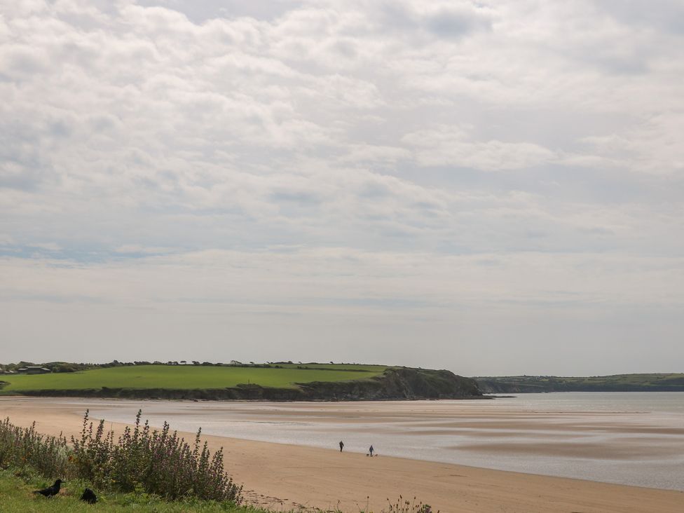 A beach with people walking near the water at Ard Uisce @ Estuary Bliss, Duncannon, County Wexford