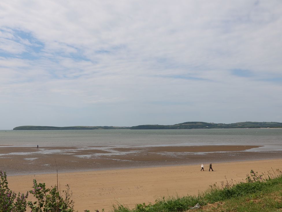 A beach with people walking along the shore at Ard Uisce @ Estuary Bliss, Duncannon, County Wexford