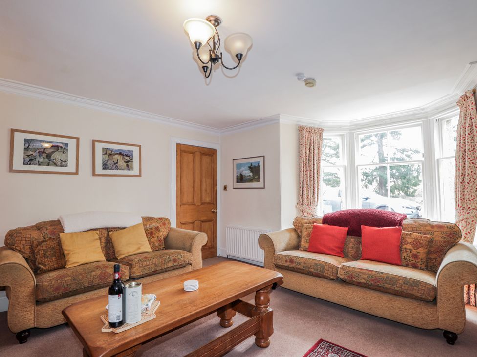 A living room with sofas and a coffee table at Achnagonlin House in Grantown-on-Spey