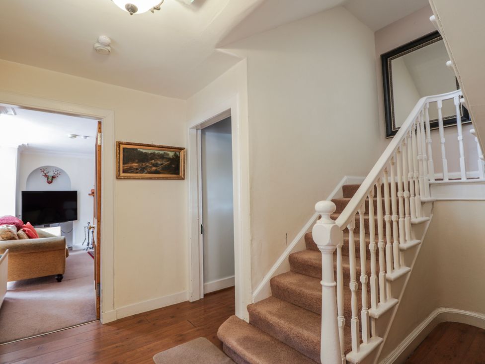 A hallway with stairs and a picture frame at Achnagonlin House in Grantown-on-Spey