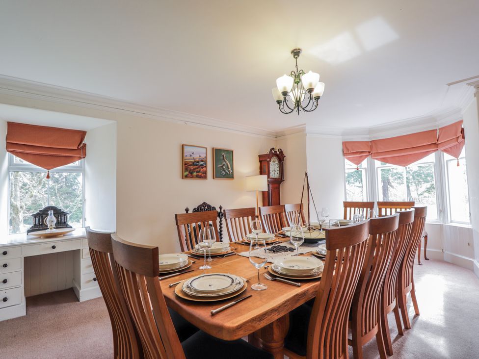 A dining room with a large table set for dinner at Achnagonlin House in Grantown-on-Spey