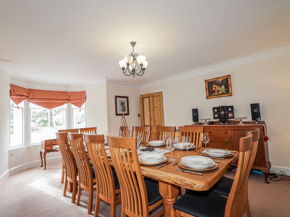 A dining room with a large table and chairs at Achnagonlin House in Grantown-on-Spey