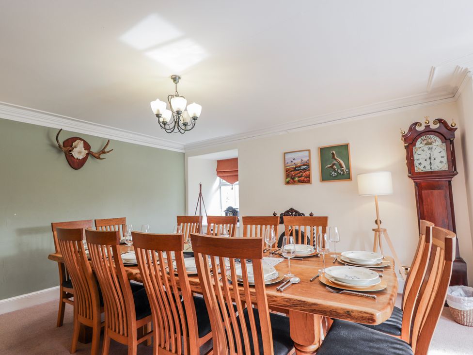 A dining room with a large table and chairs at Achnagonlin House Grantown-on-Spey