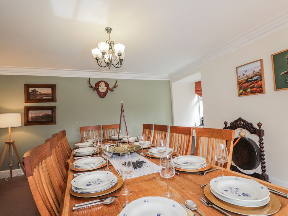 A dining room with a large table set for a meal at Achnagonlin House in Grantown-on-Spey