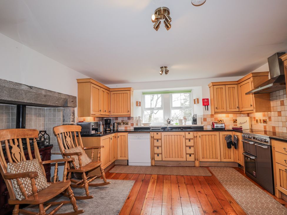 A kitchen with wooden cabinets and appliances at Achnagonlin House in Grantown-on-Spey