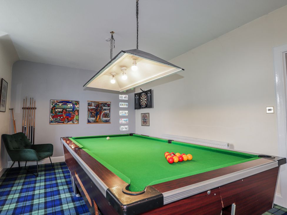 A game room with a pool table and dartboard at Achnagonlin House in Grantown-on-Spey