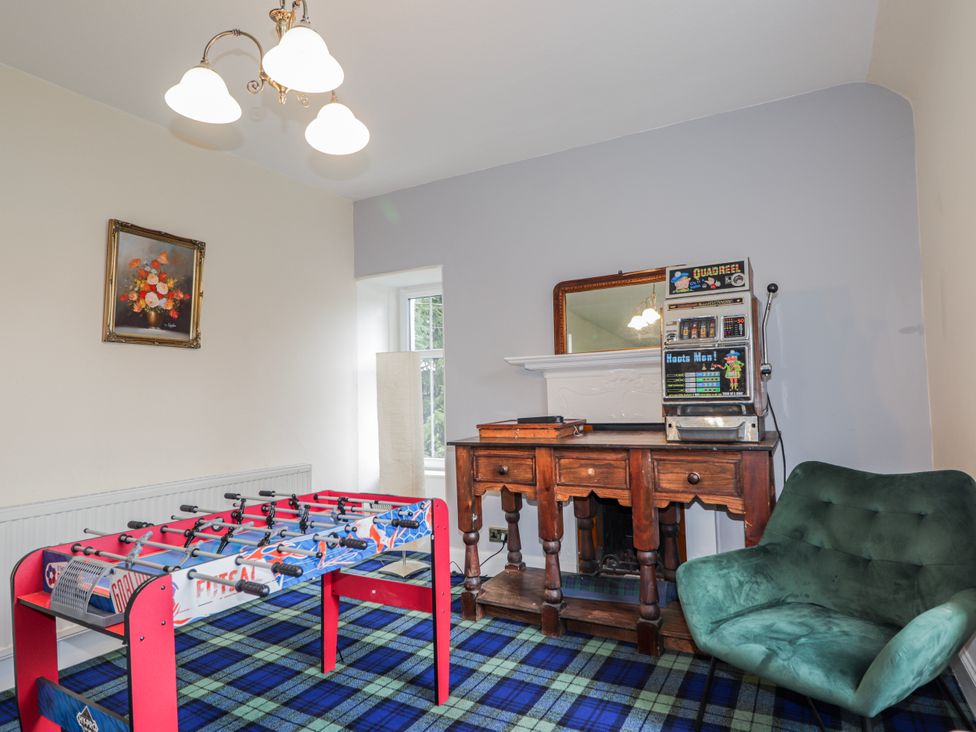 A games room with foosball table and console table at Achnagonlin House in Grantown-on-Spey