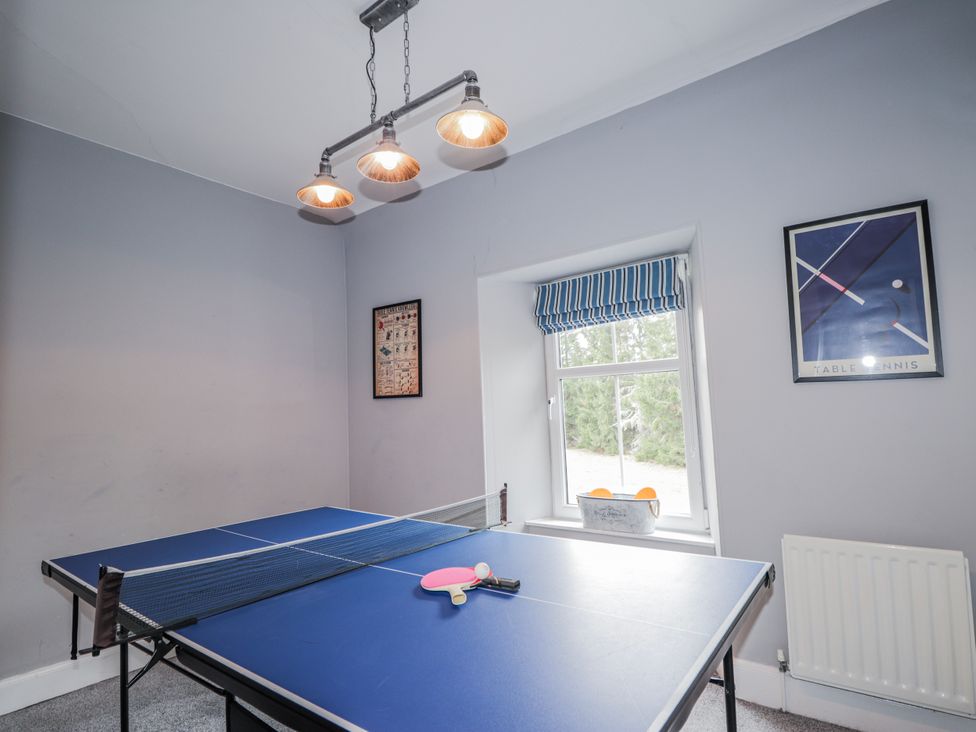 A game room with a table tennis table and wall art at Achnagonlin House in Grantown-on-Spey