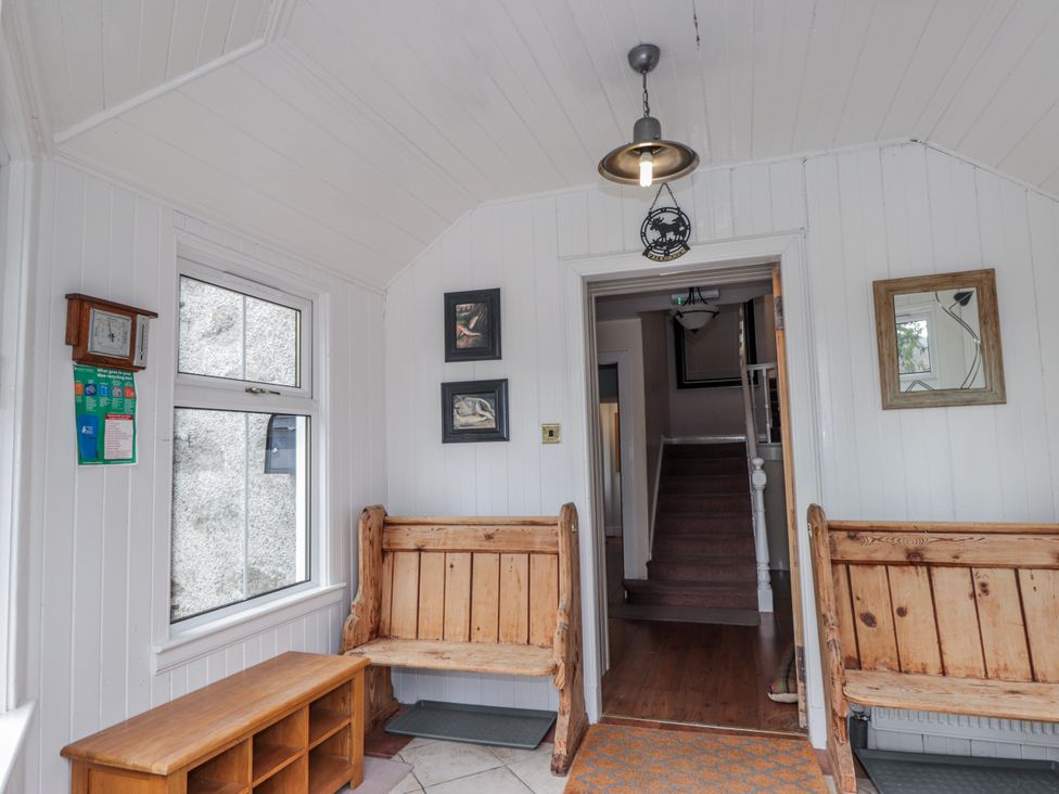 An entrance with benches and wall art at Achnagonlin House in Grantown-on-Spey