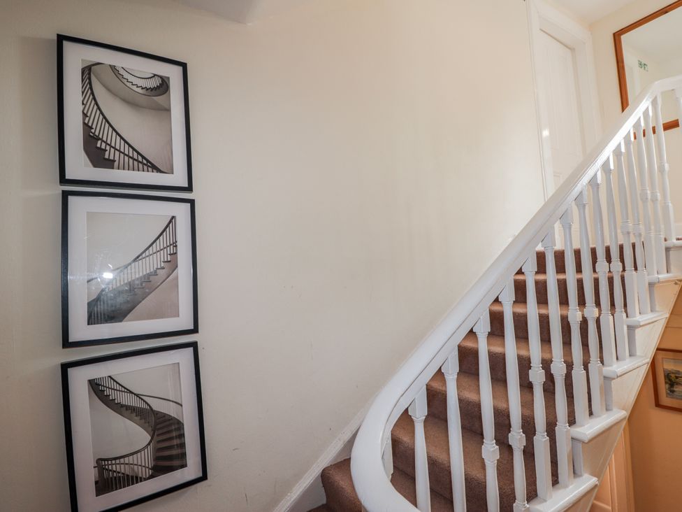 A staircase with pictures on the wall at Achnagonlin House Grantown-on-Spey