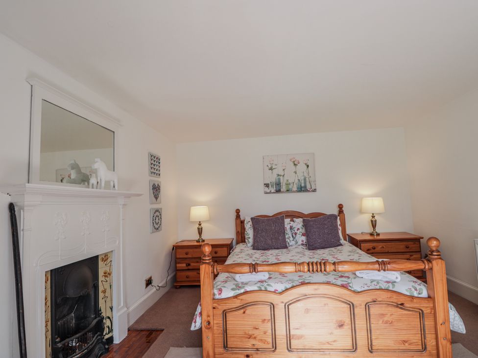 A bedroom with a bed and bedside tables at Achnagonlin House in Grantown-on-Spey