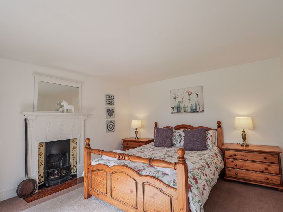 A bedroom with a bed and bedside tables at Achnagonlin House in Grantown-on-Spey