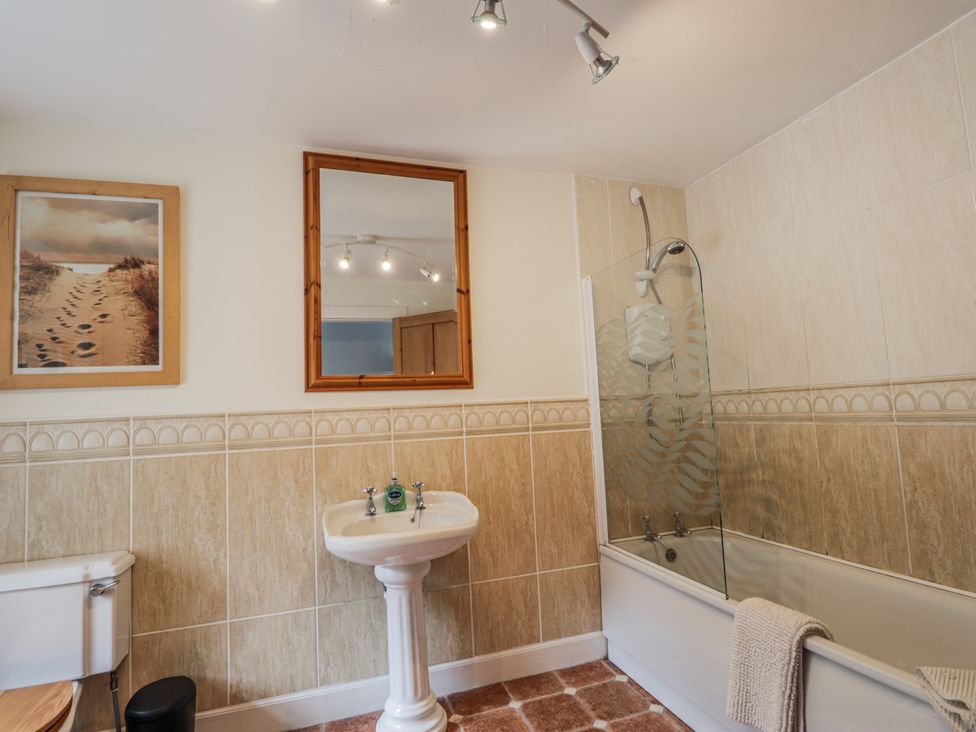 A bathroom with a bath and sink at Achnagonlin House in Grantown-on-Spey