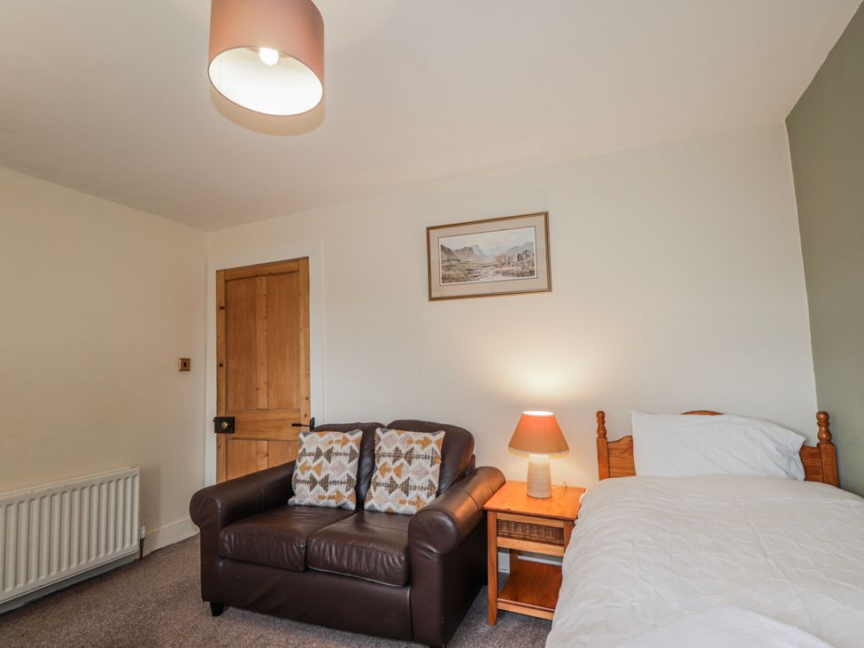 A bedroom with a bed and a couch at Achnagonlin House in Grantown-on-Spey