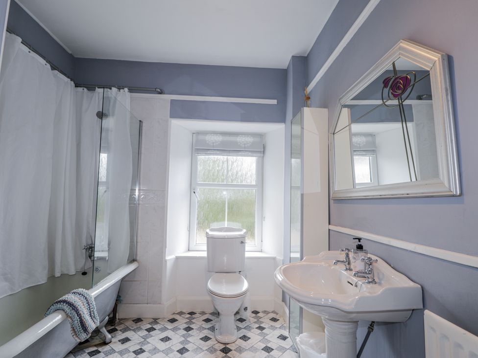 A bathroom with a bathtub, toilet, and sink at Achnagonlin House in Grantown-on-Spey