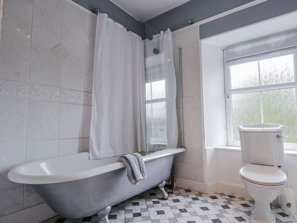 A bathroom with a bathtub and toilet at Achnagonlin House in Grantown-on-Spey