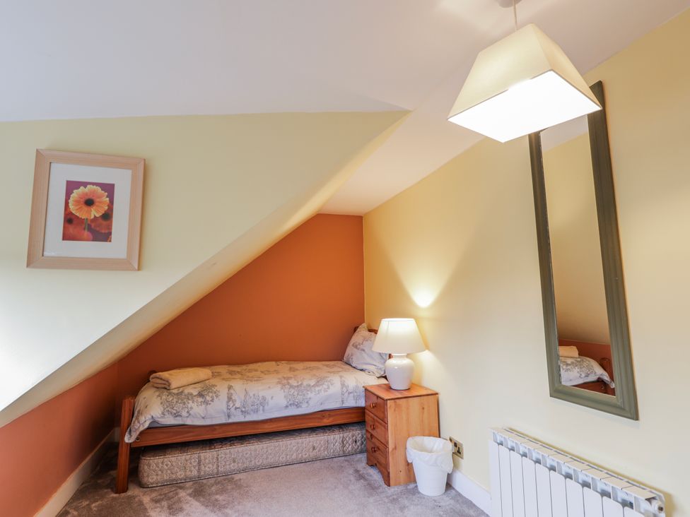 A bedroom with a bed and lamp at Achnagonlin House in Grantown-on-Spey