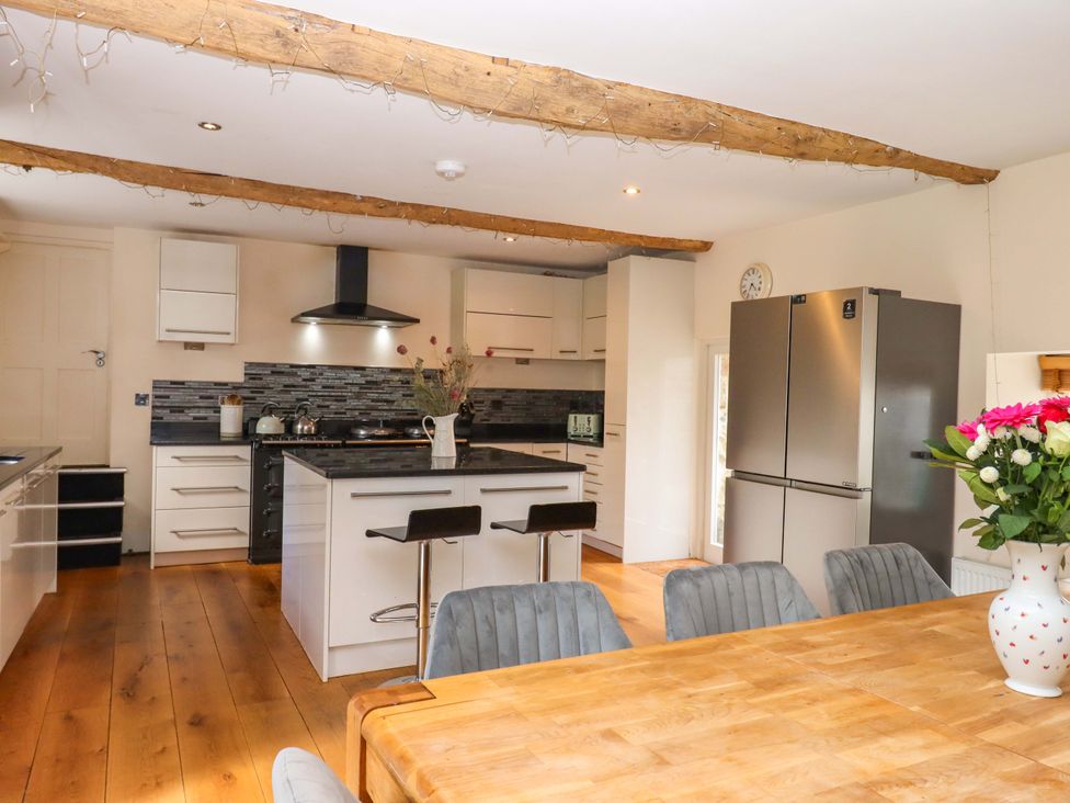 A kitchen with cabinets and an island at The Mill House in Newton Abbot