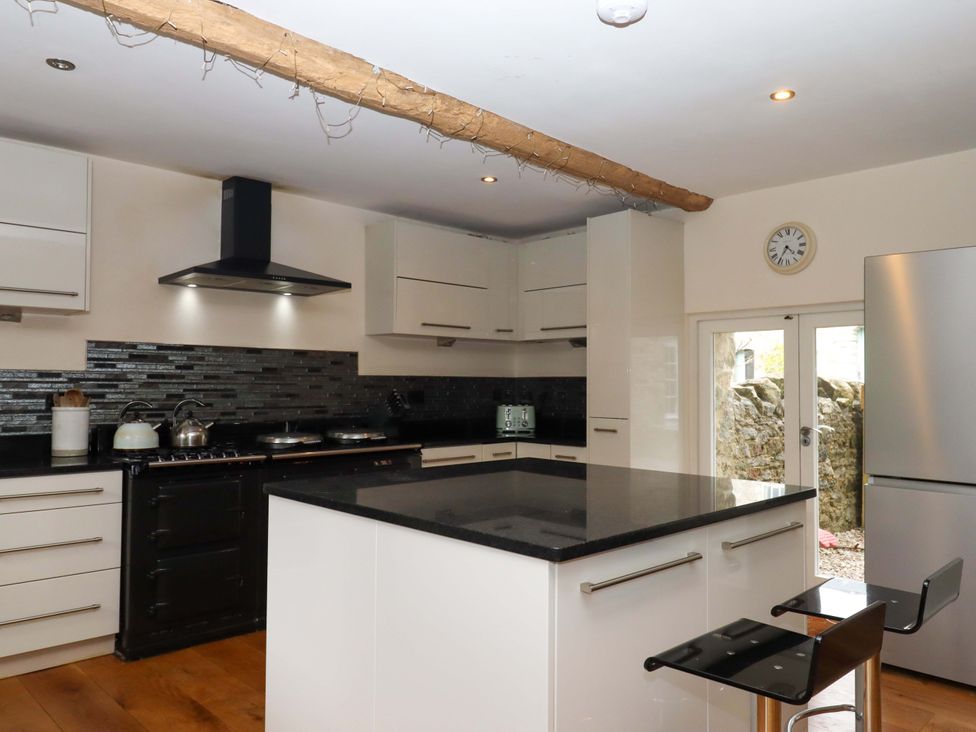A kitchen with an island and appliances at The Mill House in Newton Abbot