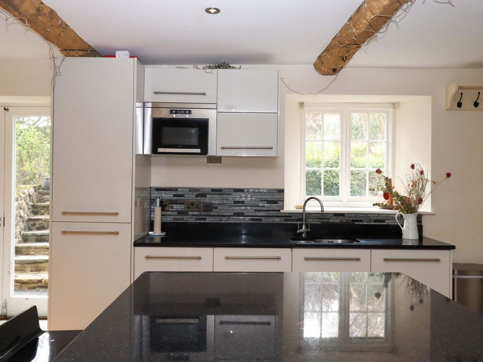A kitchen featuring cabinets, a sink, and a countertop at The Mill House in Newton Abbot