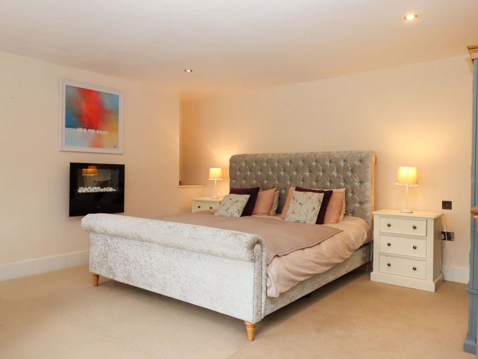 A bedroom with a bed and a bedside table at The Mill House in Newton Abbot