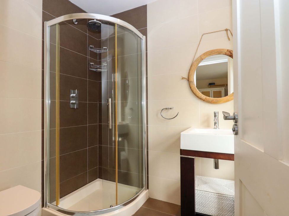 A bathroom with a shower and sink at The Mill House in Newton Abbot