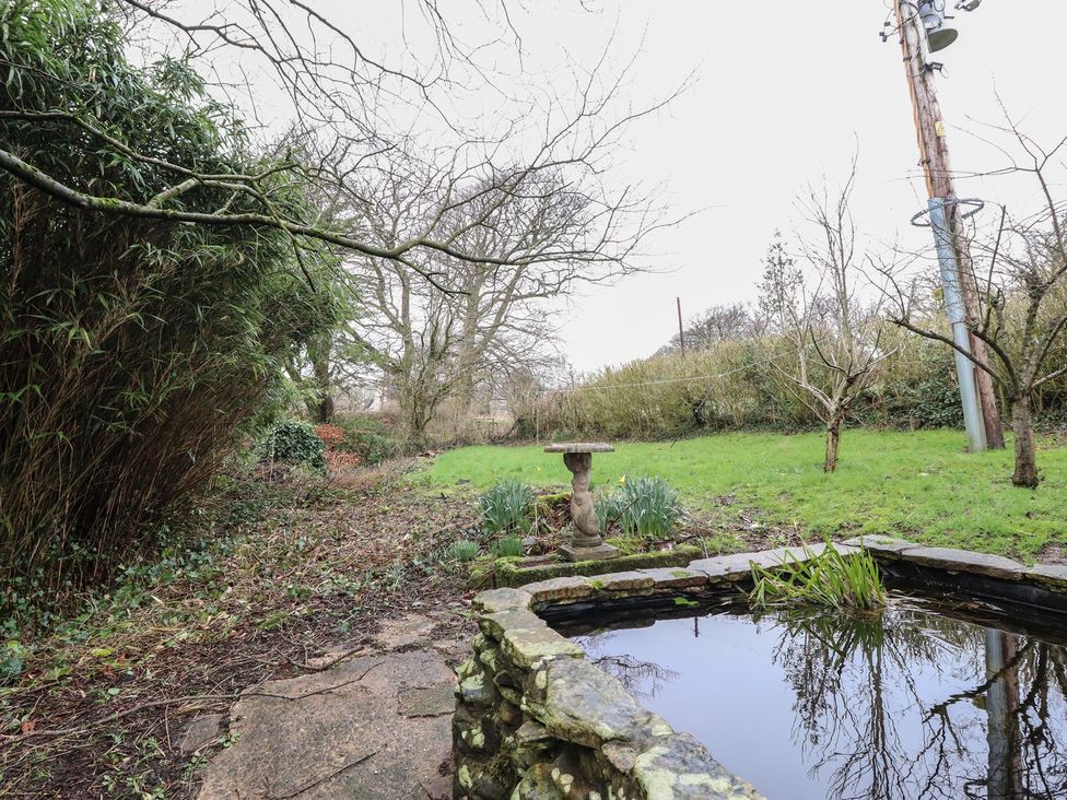 A garden with a pond and bird bath at The Lodge House Dolphinholme near Galgate