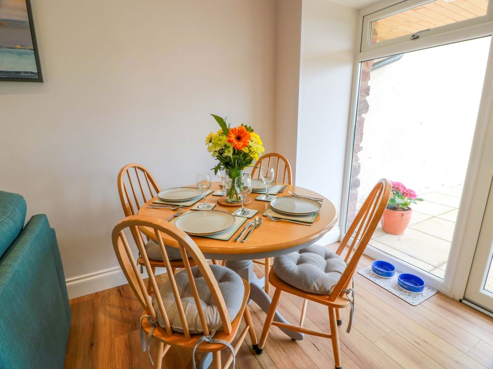 A dining area with a table set for meals at Burnside Bothy near Girvan