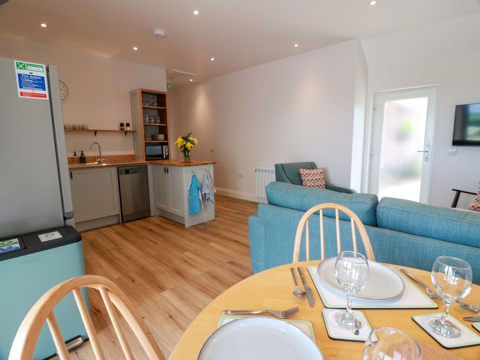 A kitchen with a dining area and seating at Burnside Bothy near Girvan