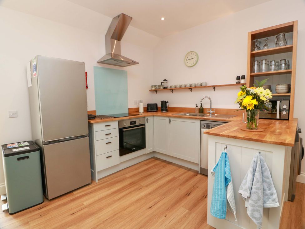 A kitchen with appliances and wooden countertops at Burnside Bothy near Girvan