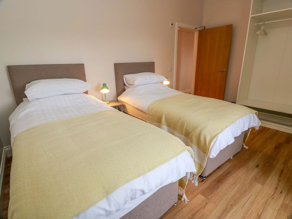 A bedroom with two single beds at Burnside Bothy near Girvan