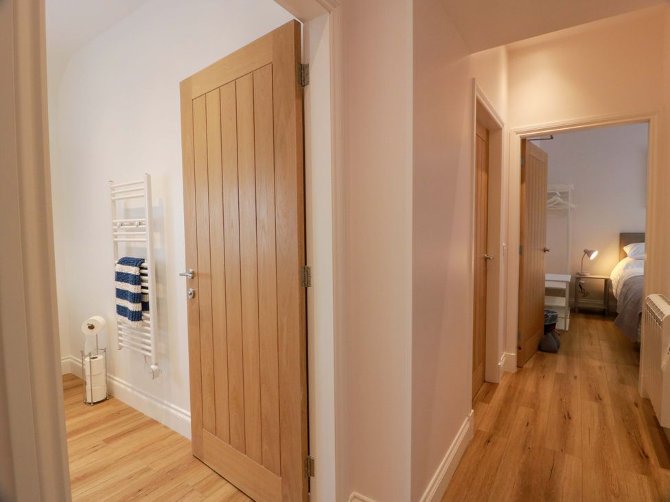 A hallway with doors leading to the bathroom and bedroom at Burnside Bothy near Girvan